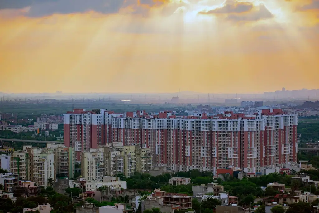 Residential high-rise towers in Noida under sunrise light